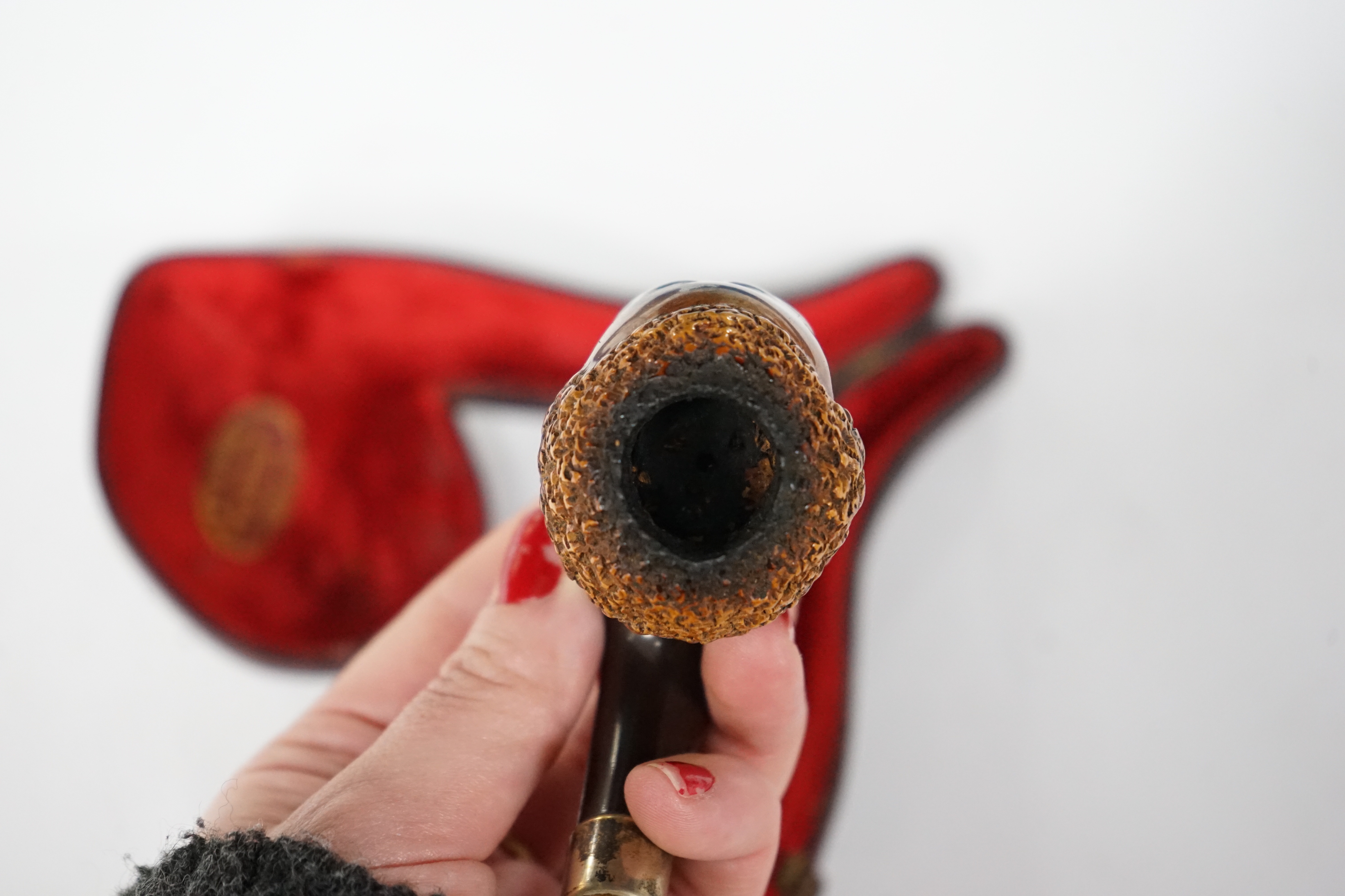 A cased Meerschaum pipe with a bowl modelled as a Nubian man’s head with metal mount and amber mouthpiece, 14cm long